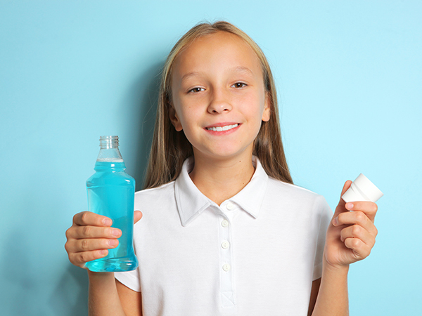 Kid using mouthwash Hudsonville MI pediatric dentist